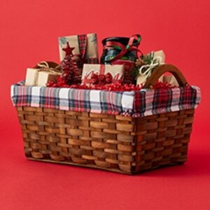 Gift basket with assorted items on red background